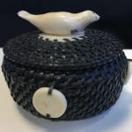 basket made from whale baleen with seal shaped walrus ivory finial